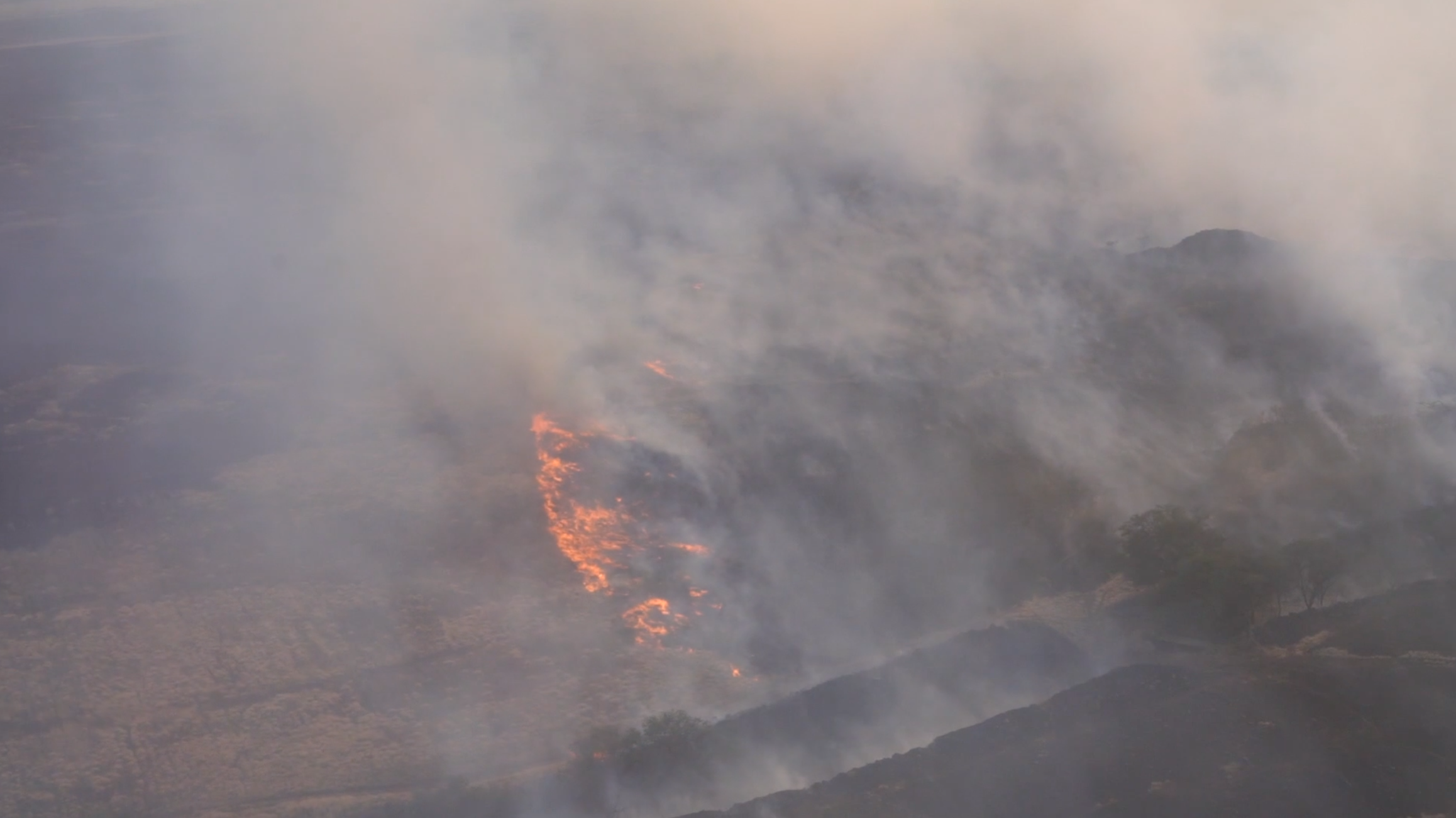 Hawaii Army National Guard helicopters fight wildfires with bucket drops, Aug. 9, 2023, in Maui, Hawaii. The National Guard said they dropped more than 100,000 gallons of water on the fires.