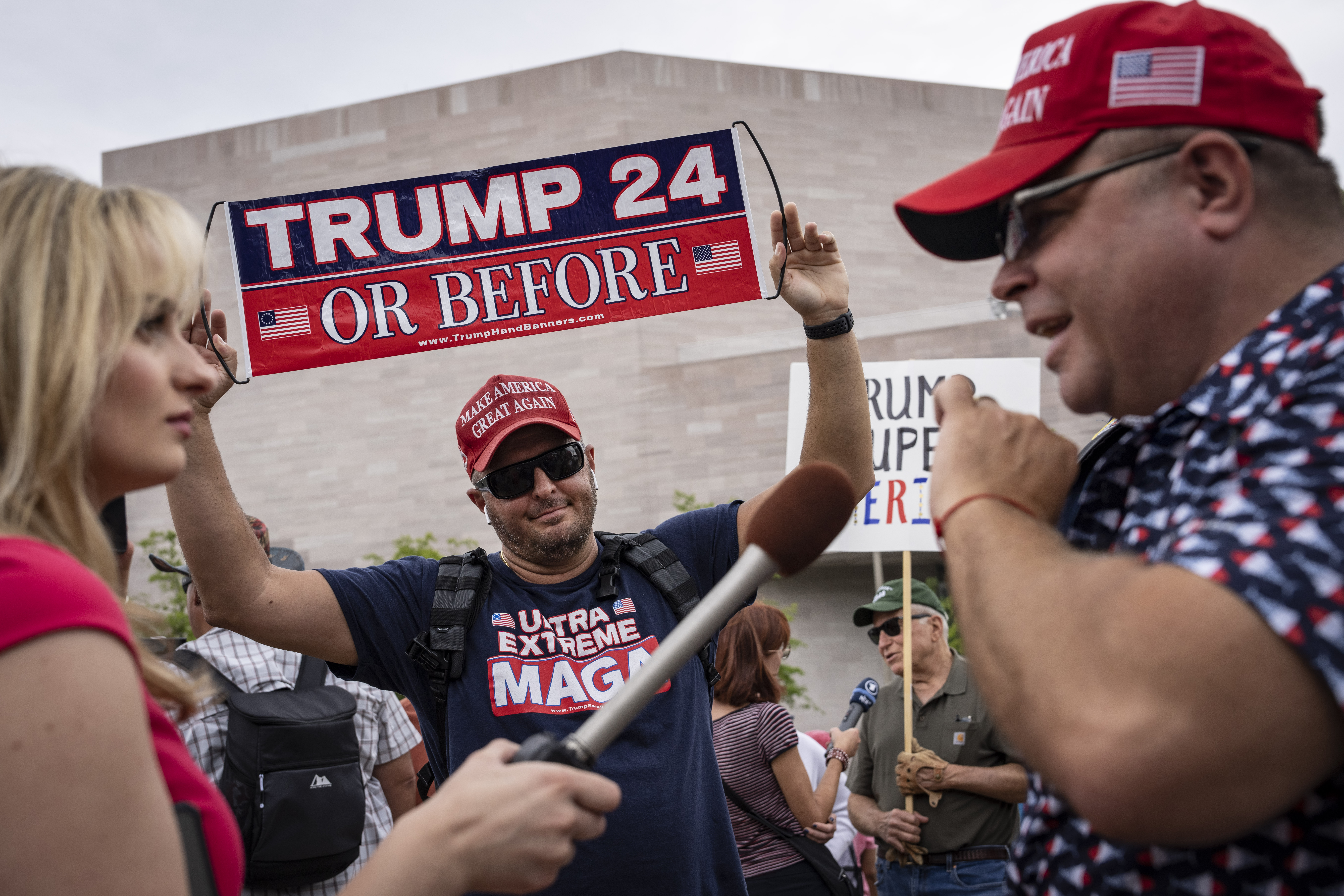 WASHINGTON, DC – AUGUST 3: A reporter interviews supporters of former U.S. President Donald Trump outside of the E. Barrett Prettyman U.S. Court House August 3, 2023 in Washington, DC. Trump was arraigned this afternoon on four felony counts for his alleged efforts to overturn the 2020 election. (Photo by Drew Angerer/Getty Images)