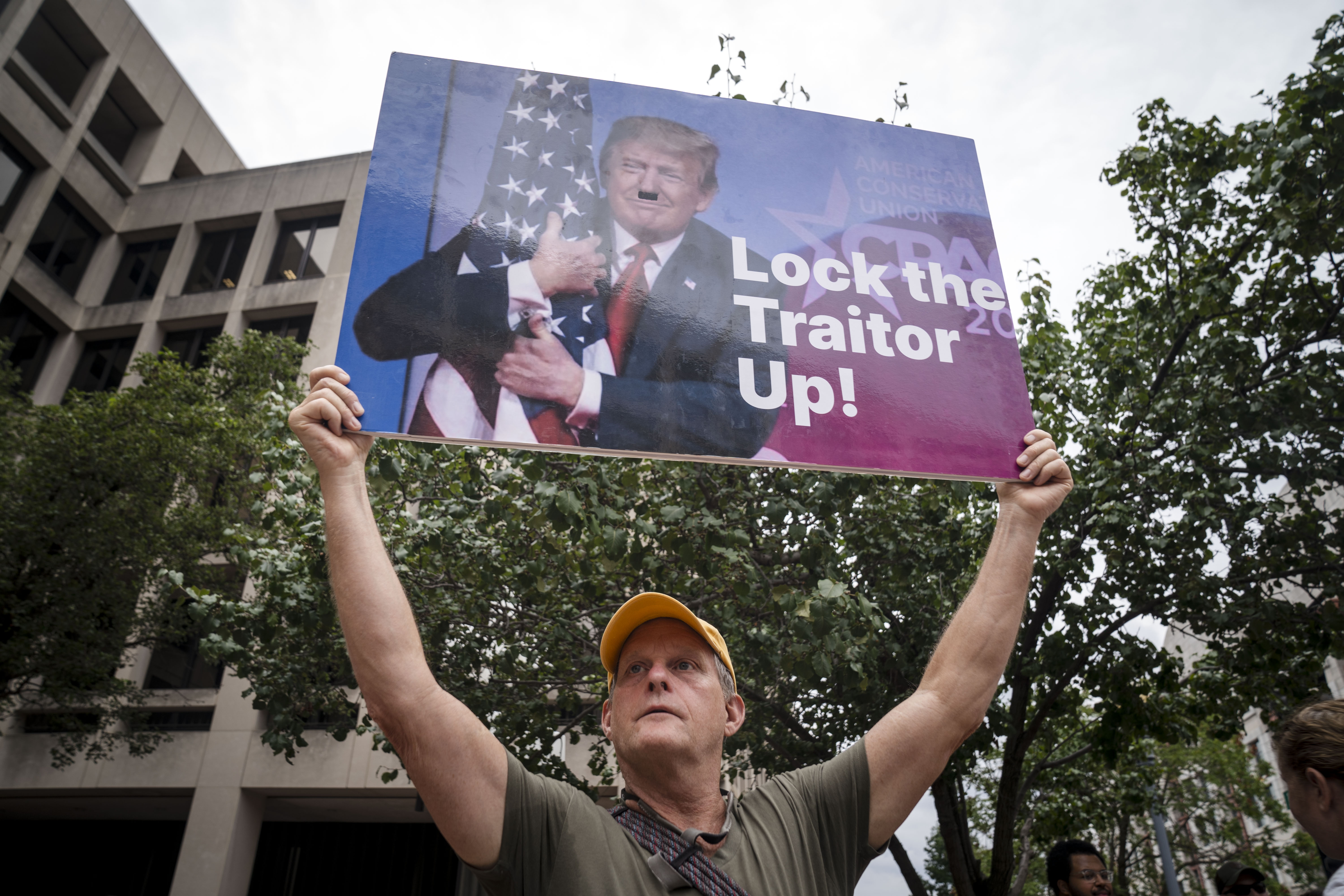 WASHINGTON, DC – AUGUST 03: A person holds up a sign with a photograph of former President Donald Trump outside of the E. Barrett Prettyman United States Courthouse on August 3, 2023 in Washington, DC. President Donald Trump arrived at the Courthouse to be arraigned on Thursday afternoon after being indicted on four felony counts for his alleged efforts to overturn the 2020 election. (Photo by Kent Nishimura/Getty Images)