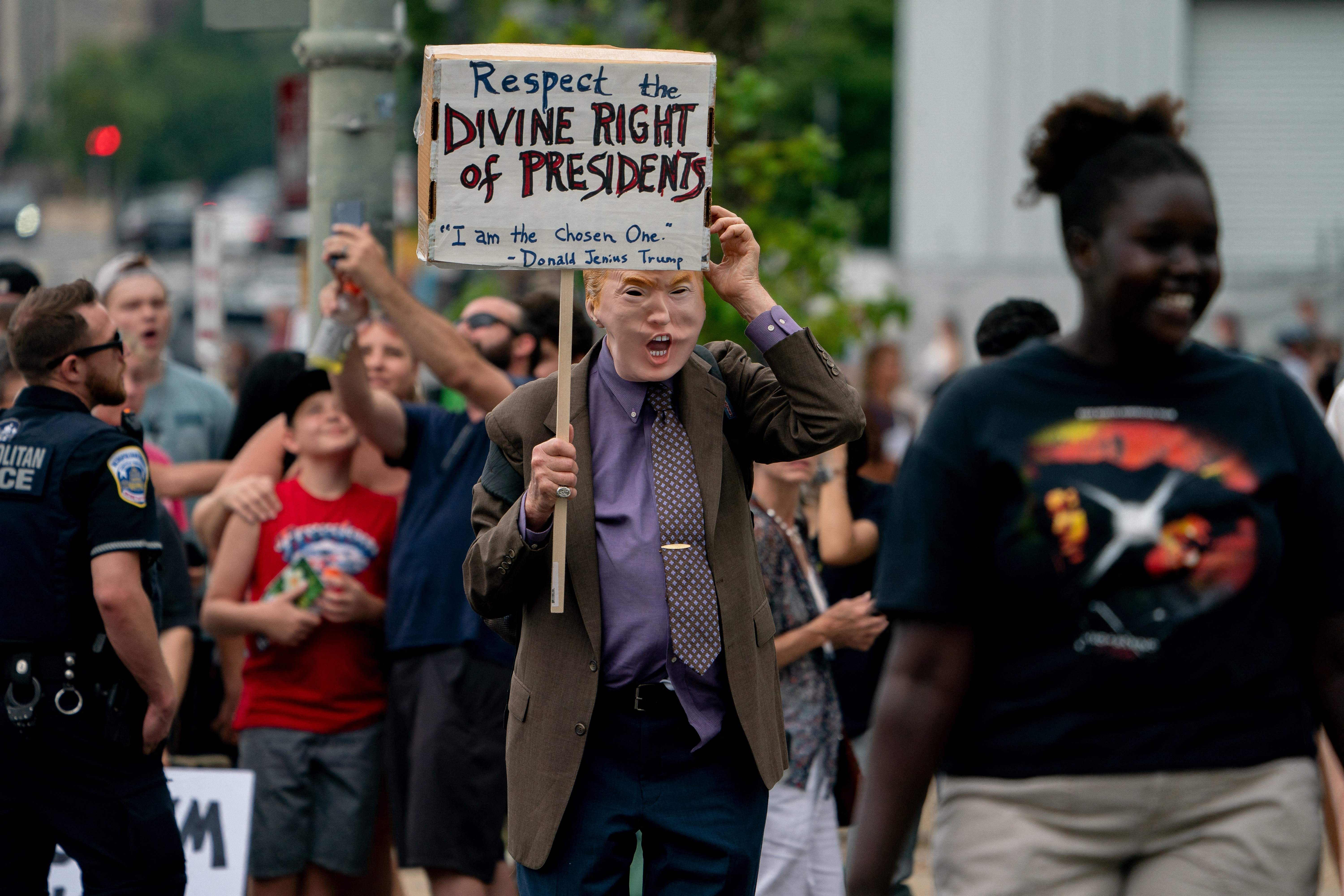 Demonstrators stand outside the E. Barrett Prettyman US Courthouse in Washington, DC, on August 3, 2023, ahead of the arraignment of former US President Donald Trump. Trump pleaded not guilty to criminal charges that he conspired to overturn the results of the 2020 election and defraud the American people. (Photo by Stefani Reynolds / AFP) (Photo by STEFANI REYNOLDS/AFP via Getty Images)