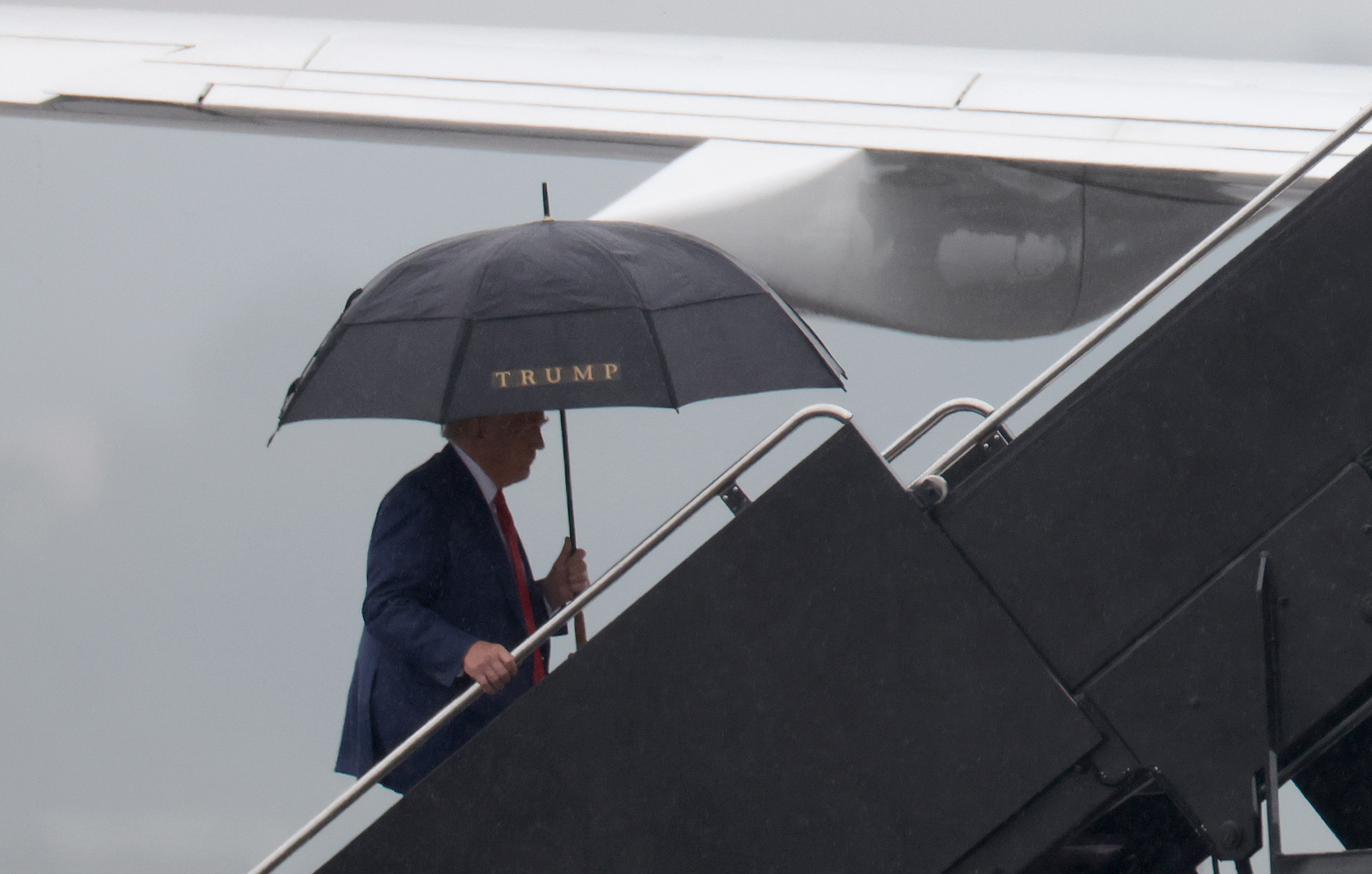 ARLINGTON, VIRGINIA – AUGUST 03: Former U.S. President Donald Trump boards his plane at Reagan National Airport following an arraignment in Washington, D.C. federal court on August 3, 2023 in Arlington, Virginia. Trump pleaded not guilty to four felony criminal charges during his arraignment this afternoon after being indicted for his alleged efforts to overturn the 2020 election. (Photo by Win McNamee/Getty Images)