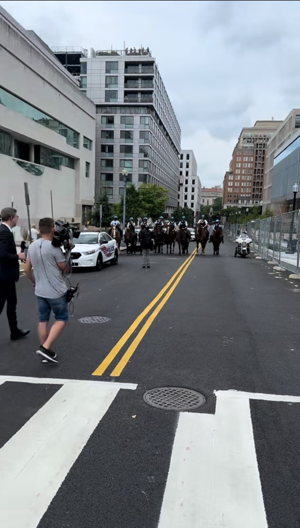 Police on horseback line the end of C Street NW behind the E Barrett Prettyman Courthouse, where former President Donald Trump was arraigned on Thursday afternoon.