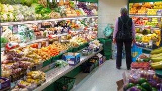 A shopper browses fruit and vegetables for sale at an indoor market in Sheffield, UK. The OECD recently predicted that the UK will experience the highest inflation among all advanced economies this year.