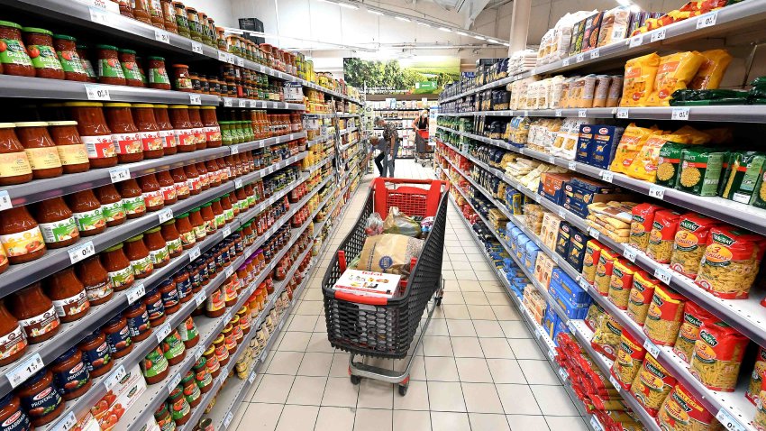 Shopping cart in a department of a Carrefour supermarket, in front of pastas and sauces.