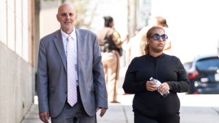 File photo: Deja Nicole Taylor, right, arrives with attorney James Ellenson, to the Newport News Sheriffs Office in Newport News, Virginia, on April 13, 2023, to turn herself in. Taylor is the mother of the 6-year-old first grader who shot his teacher at Richneck Elementary School on Jan. 6. (Billy Schuerman/Daily Press/Tribune News Service via Getty Images)