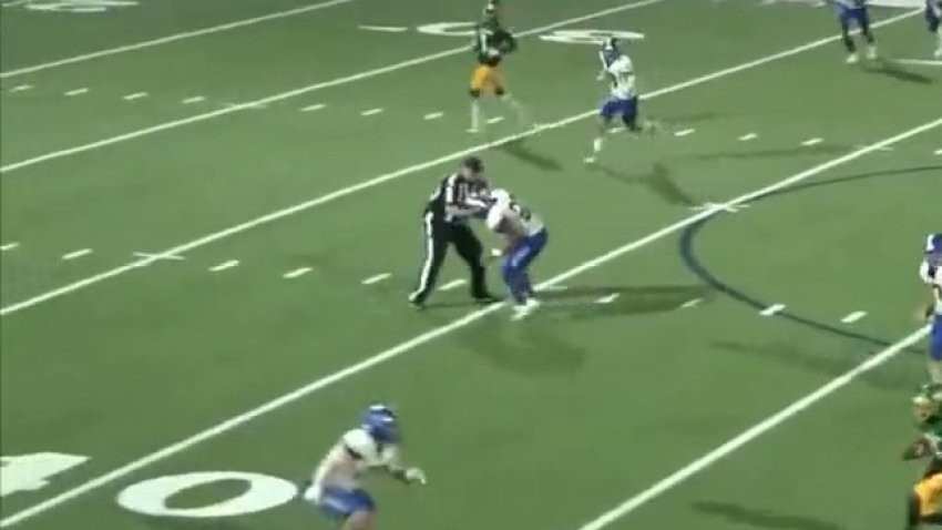 A screenshot from a video shows an incident between a referee and player during a high school football game Friday night between Whitney High and Dallas Madison.