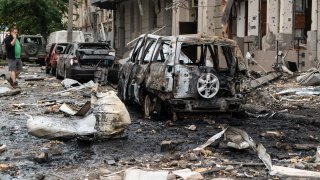 Destroyed cars stand amid debris in the central residential district hit by Russian Iskander missile on the morning on October 6, 2023 in Kharkiv, Ukraine. 