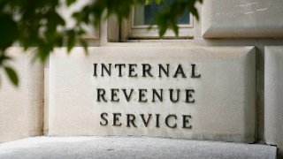 A sign outside the Internal Revenue Service building is seen, May 4, 2021, in Washington. The IRS plans to invite a select group of taxpayers across 13 states to try out the agency’s pilot electronic free file tax return system, beginning this January.