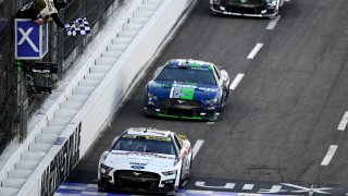 Ryan Blaney, driver of the No. 12 Discount Tire Ford, takes the checkered flag to win the NASCAR Cup Series Xfinity 500 at Martinsville Speedway on Oct. 29, 2023 in Martinsville, Va.