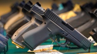 Handguns are displayed at a pawn shop Monday, July 18, 2022, in Auburn, Maine.