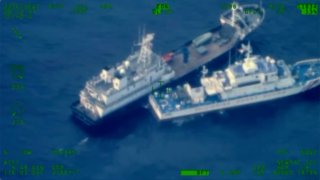 This image released by the Armed Forces of the Philippines, shows a Chinese militia vessel, top, and Philippine coast guard vessel BRP Cabra as they approach Second Thomas Shoal, locally called Ayungin Shoal, at the disputed South China Sea on Sunday Oct. 22, 2023.