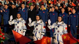 Chinese astronauts for the Shenzhou-17 mission, from left, Jiang Xinlin, Tang Hongbo and Tang Shengjie wave as they attend a send-off ceremony for their manned space mission at the Jiuquan Satellite Launch Center in northwestern China, Thursday, Oct. 26, 2023.