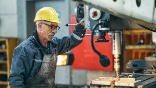 Turner worker working on drill bit in a workshop