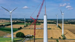 A wind turbine installation taking place in Germany on July 14, 2023. The International Energy Agency is calling for a surge in renewable energy installations over the next few years.