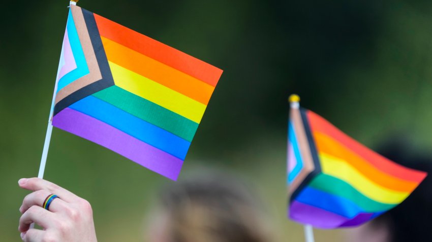 Students hold flags as they protest against Katy ISD's new transgender policy