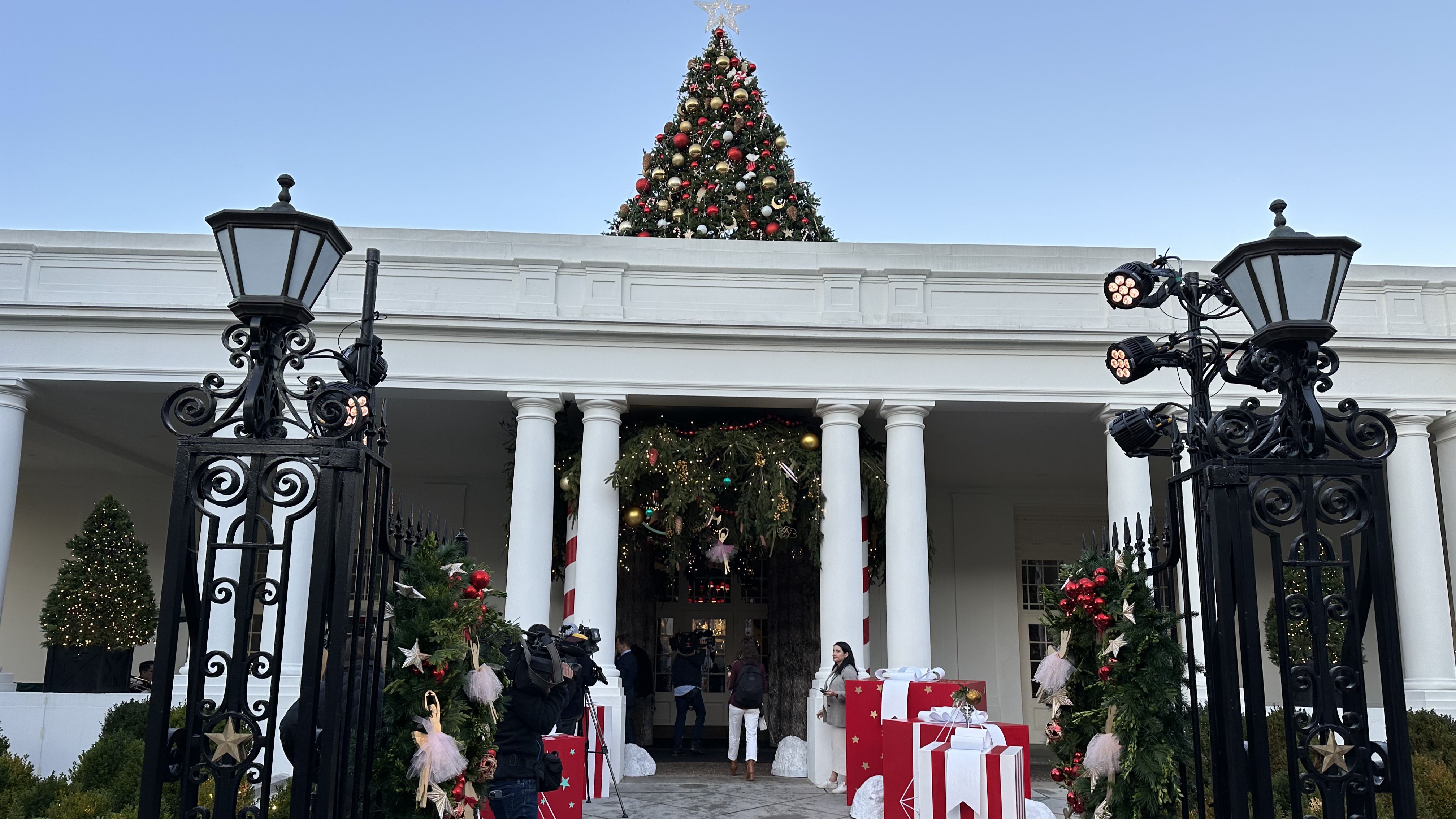 Guests enter the East Wing under the branches of a giant Christmas tree.