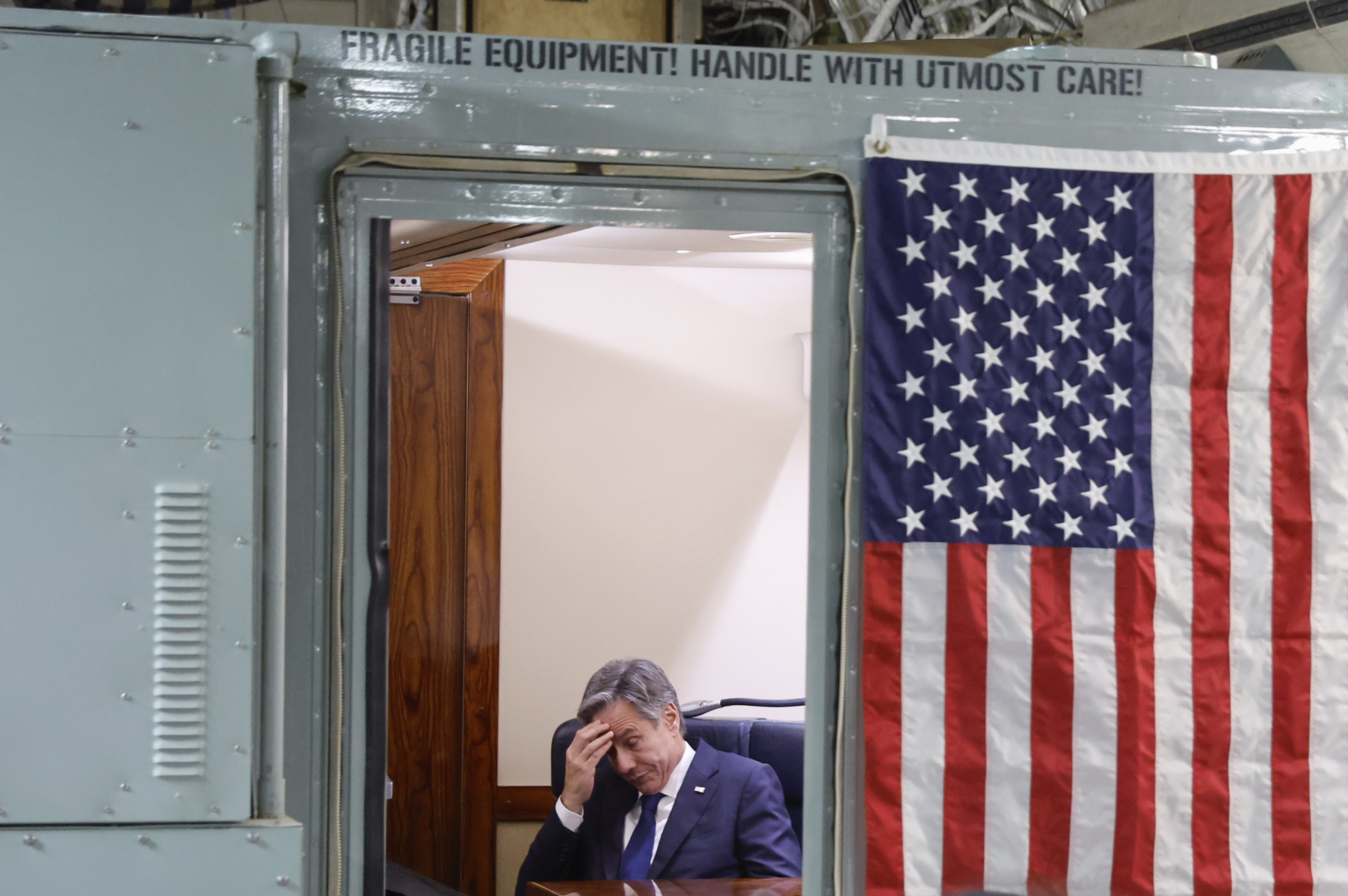 U.S. Secretary of State Antony Blinken sits onboard the plane during his visit to Israel as he departs en route to Jordan, Friday, Nov. 3, 2023. Blinken is in Israel to press for more humanitarian aid to be allowed into besieged Gaza.