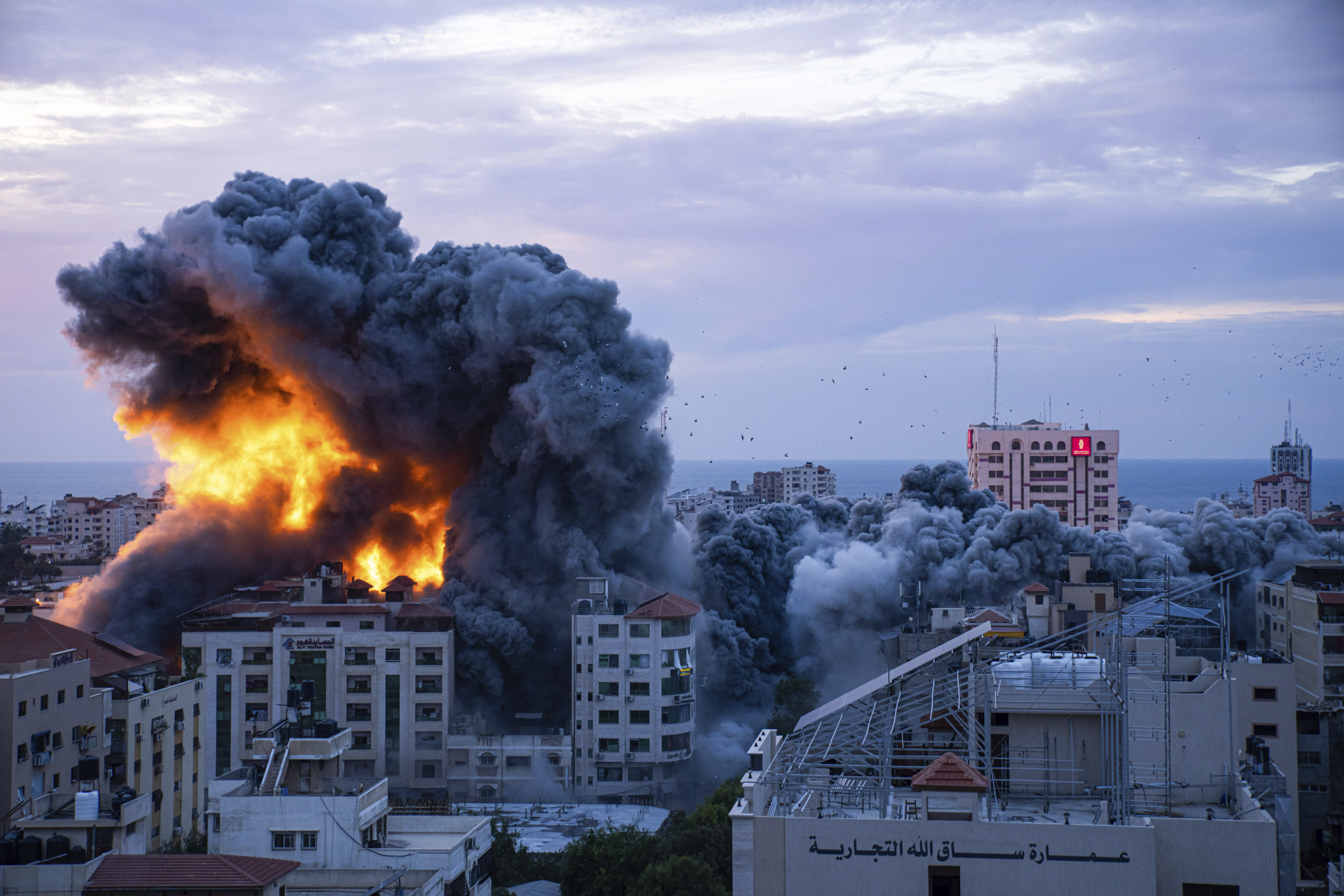 Fire and smoke rises following an Israeli airstrike, in Gaza City, Saturday, Oct. 7, 2023. Six weeks of fighting since then has seen hundreds of thousands of Palestinians flee to southern Gaza, where they cram into shelters and take refuge with friends and family.