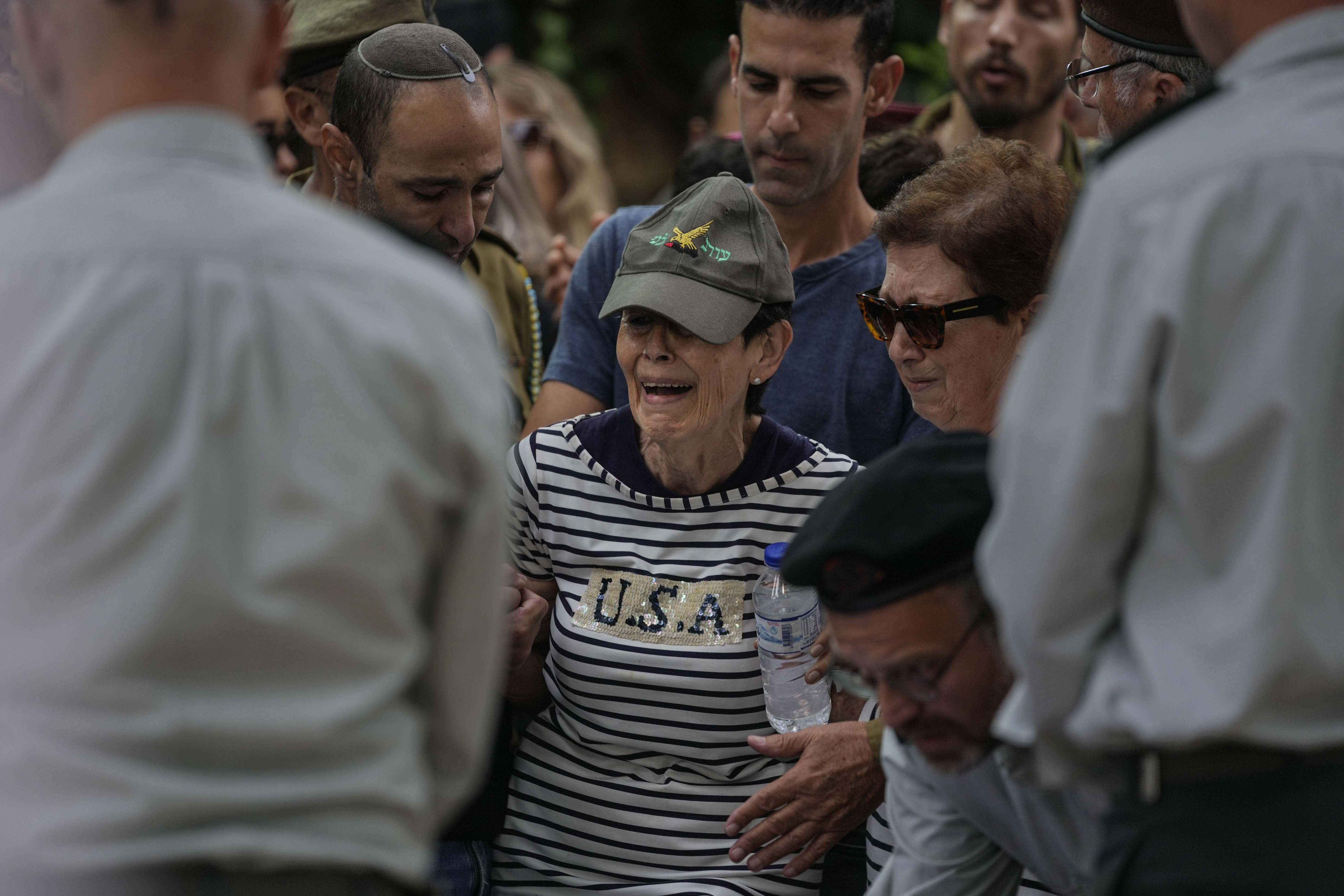 The mother of Israeli Col. Roi Levy cries during her son’s funeral at the Mount Herzl cemetery in Jerusalem on Monday, Oct. 9, 2023. Col. Roi Levy was killed after Hamas militants stormed from the blockaded Gaza Strip into nearby Israeli towns. Israel’s vaunted military and intelligence apparatus was caught completely off guard, bringing heavy battles to its streets for the first time in decades.