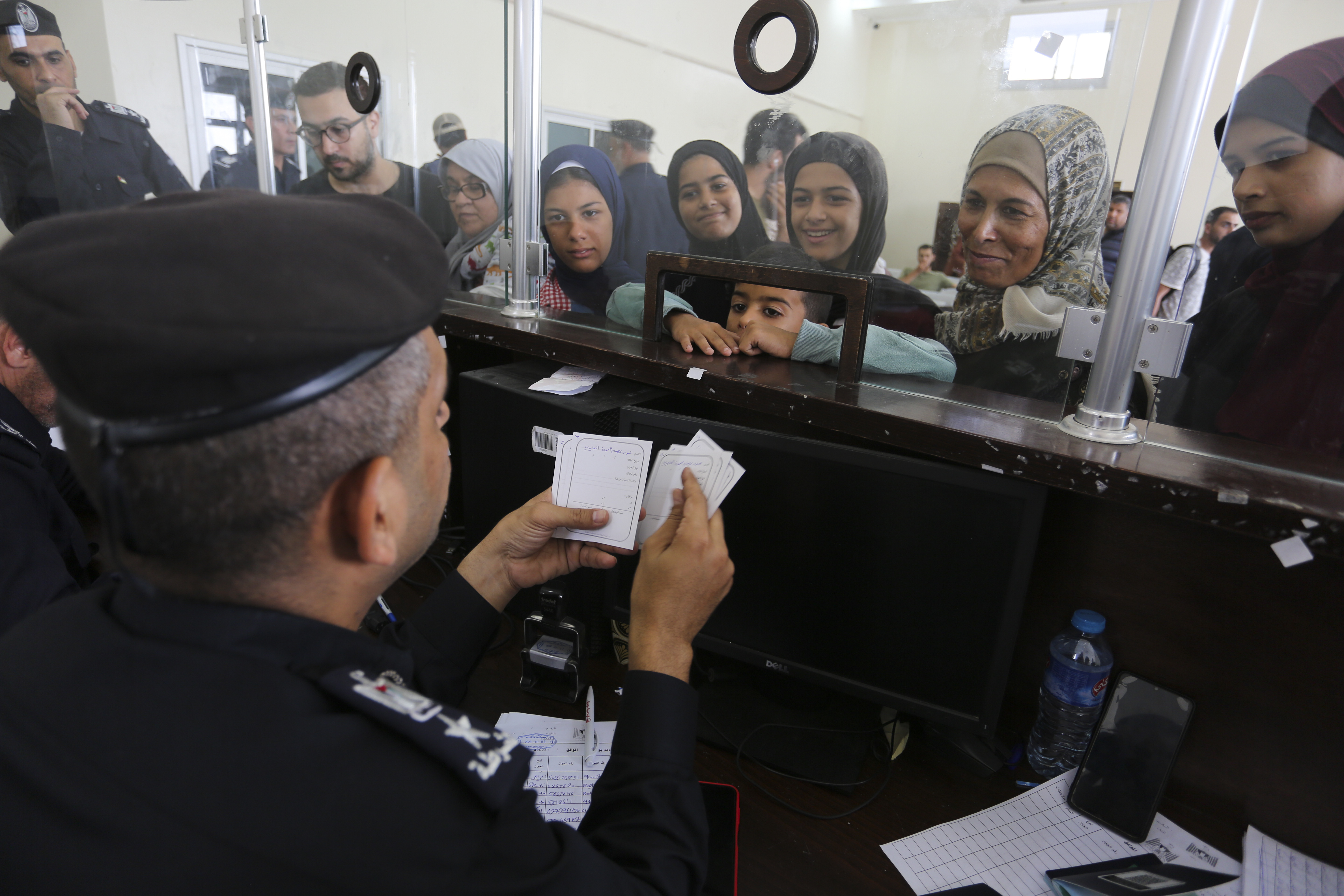 Palestinians with dual nationality register to cross to Egypt on the Gaza Strip side of the border crossing in Rafah on Thursday, Nov. 2, 2023.