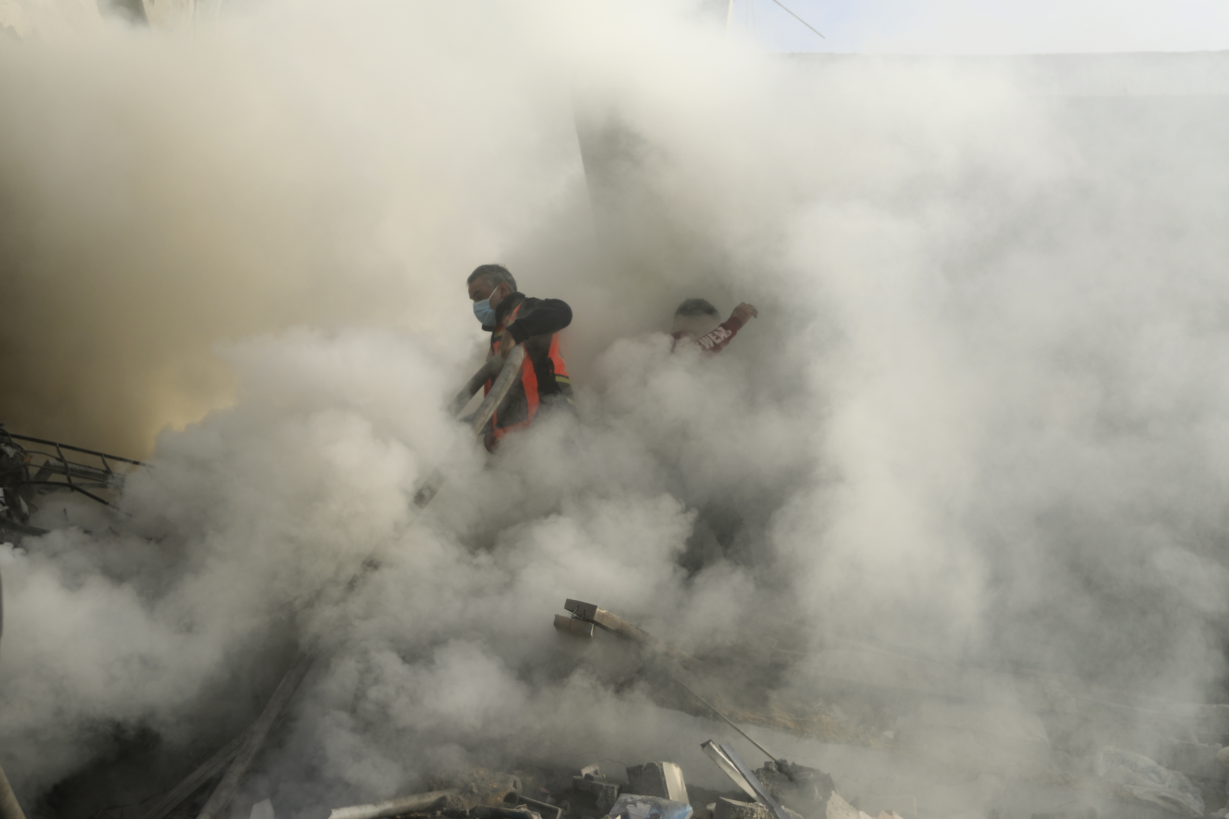 Palestinian firefighters extinguish fire caused by an Israeli airstrike in Khan Younis refugee camp, southern Gaza Strip, Tuesday, Nov. 7, 2023.