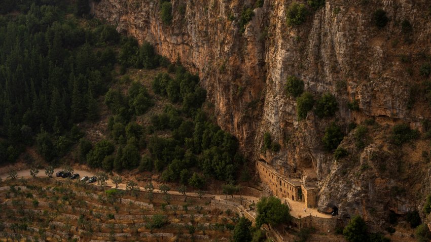 Tourists visit the Saint Elisha monastery inside the Kadisha Valley, a holy site by Lebanon's Christians, in the northeast mountain town of Bcharre, Lebanon, Friday, July 21, 2023. For Lebanon's Christians, the cedars are sacred, these tough evergreen trees that survive the mountain's harsh snowy winters.