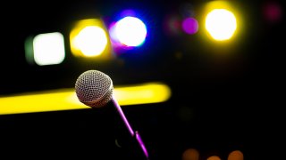 Comedy Club Show Microphone on Stage in Club with Blue Purple Yellow Stage Lighting Lights and Colors