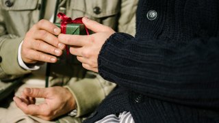 Two men exchange presents.