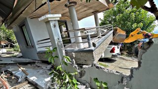 a damaged house in the town of Malapatan, Sarangani province