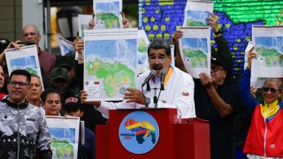 President of Venezuela Nicolas Maduro shows a national map during a march in favor of the Venezuelan position regarding the dispute over the territory of Essequibo