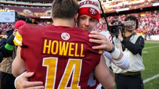 Brock Purdy #13 of the San Francisco 49ers and Sam Howell #14 of the Washington Commanders meet after a game at FedExField on Dec. 31, 2023.