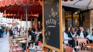 Customers sit outside at a cafe terrace in Paris, France, on Nov. 10, 2021.