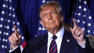 Republican presidential candidate and former U.S. President Donald Trump gestures as he takes the stage during his New Hampshire presidential primary election night watch party, in Nashua, New Hampshire, U.S., January 23, 2024. 