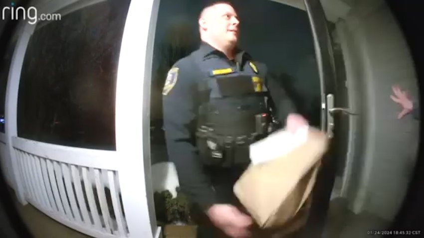 A doorbell camera of a sheriff's deputy with a bag of food