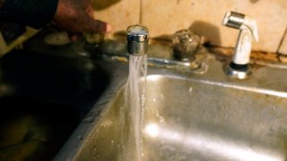 FILE - Water flows from a home on Sept. 7, 2022, in south Jackson, Miss.