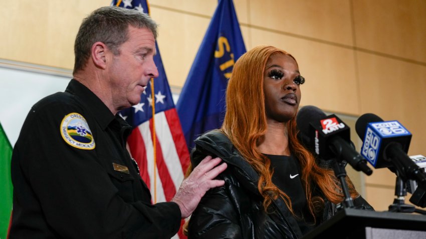 Portland Fire and Rescue spokesman Rick Graves, left, introduces Majiah Washington to speak during a news conference at the Portland Fire & Rescue headquarters on Thursday, Jan. 18, 2024, in Portland, Ore. A power line fell on a parked car in northeast Portland on Wednesday, killing three people and injuring a baby during an ice storm. Washington, who saw the incident unfold through her window, rushed outside to grab the baby from one of the people lying in the street to save its life. (AP Photo/Jenny Kane)