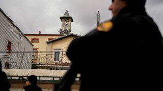 Turkish police officers stand guard in a cordoned off area outside the Santa Maria church, in Istanbul.