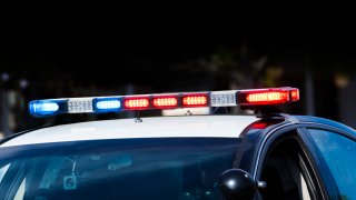 A police car at a crime scene.