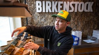 Employee Mo Soto arranges a shelf at a Birkenstock store on October 10, 2023 in Venice, California. 