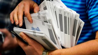 FILE - Mail-in ballots to be sorted for the 2020 General Election, Oct. 23, 2020, in West Chester, Pa.