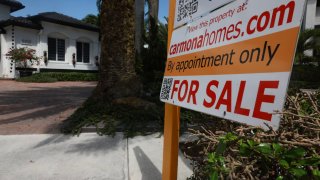 A ‘For Sale’ sign is posted on the lawn in front of a home on March 15, 2024, in Miami, Florida. 