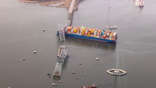 In an aerial view, cargo ship Dali is seen after running into and collapsing the Francis Scott Key Bridge on March 26, 2024 in Baltimore, Maryland. 