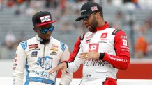 NORTH WILKESBORO, NORTH CAROLINA - MAY 20: Bubba Wallace, driver of the #1 Pristine Auction Toyota, (R) and Rajah Caruth, driver of the #24 Wendell Scott Foundation Chevrolet, talk on the grid during qualifying for the NASCAR Craftsman Truck Series Tyson 250 at North Wilkesboro Speedway on May 20, 2023 in North Wilkesboro, North Carolina. (Photo by Chris Graythen/Getty Images)