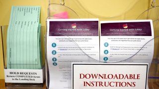 Instructions for using Libby, a free app for e-books, digital audiobooks and magazines is on display at the Windsor Public Library in Windsor, Conn., Feb. 1, 2024. Libraries have been grappling with soaring costs of digital titles, both e-books and audio books, that libraries typically lease from publishers for a year or two, with limited usage. (AP Photo/Jessica Hill)