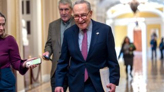 Senate Majority Leader Chuck Schumer, D-N.Y., walks outside the chamber as he tries to assemble enough lawmakers to begin the final steps of completing a partial government funding bill, at the Capitol in Washington, Friday, March 8, 2024.