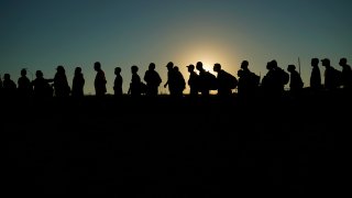 FILE - Migrants who crossed the Rio Grande and entered the U.S. from Mexico