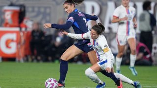 FILE – San Diego Wave forward Alex Morgan, left, controls the ball as OL Reign defender Lauren Barnes defends during the second half of an NWSL semifinal playoff soccer match Sunday, Nov. 5, 2023, in San Diego. The National Women’s Soccer League has a lot to be excited about heading into its 11th season. (AP Photo/Gregory Bull, File)