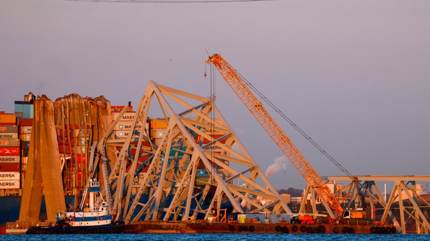 Cranes stand by as the wreckage of the Francis Scott Key Bridge rests on the container ship Dali