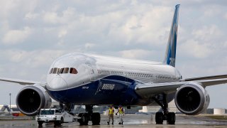 FILE - In this March 31, 2017, file photo, Boeing employees walk the new Boeing 787-10 Dreamliner towards the delivery area at the company's facility in South Carolina.