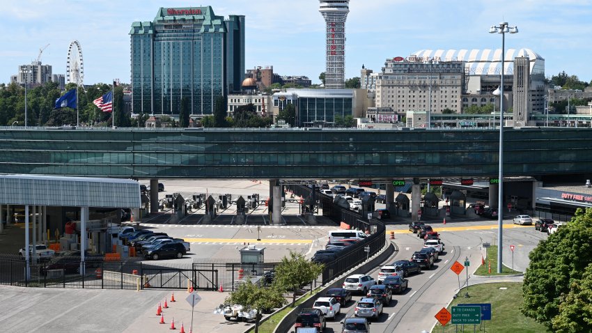 FILE - Cars wait in line to go through US customs at the Rainbow Bridge between Niagara Falls, New York